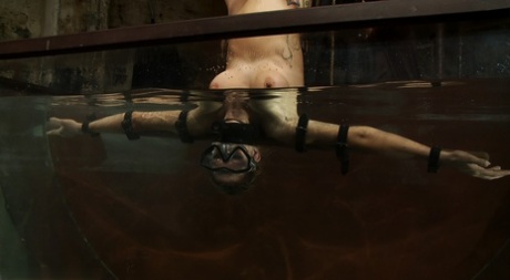 Blonde Rain DeGrey gets fucked by a machine dildo in underwater BDSM action