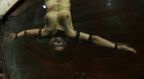 Blonde Rain DeGrey gets fucked by a machine dildo in underwater BDSM action