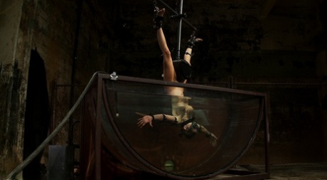 Blonde Rain DeGrey gets fucked by a machine dildo in underwater BDSM action