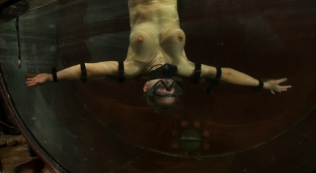 Blonde Rain DeGrey gets fucked by a machine dildo in underwater BDSM action
