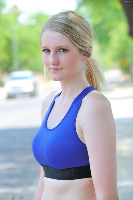 Delightful teen jogger Summer reveals her fine figure and poses in the park