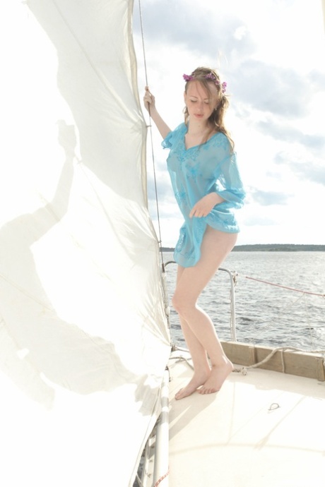 Brunette teen Vega presents her petite body and poses on a yacht