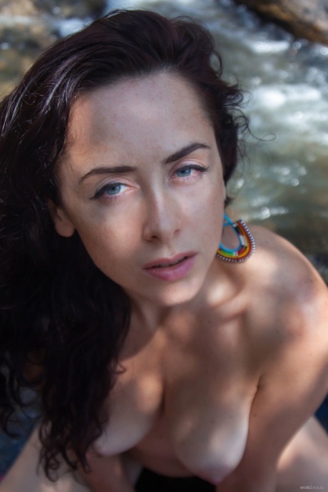 Fine brunette lady Madivya reveals her stunning boobs in the river
