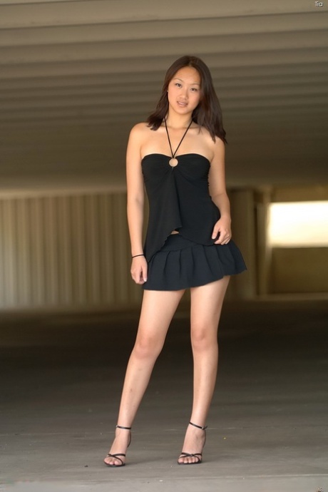 Shy Asian babe Tia screwing her innocent pussy with a red toy in public