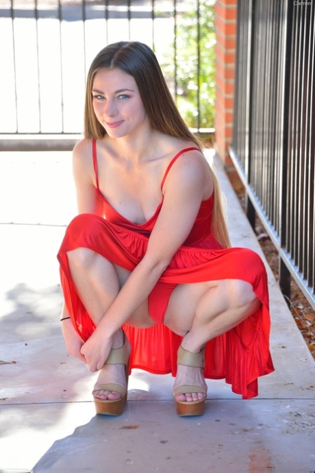 Adorable teen with small boobs Carmen doffs her red dress and flaunts her body